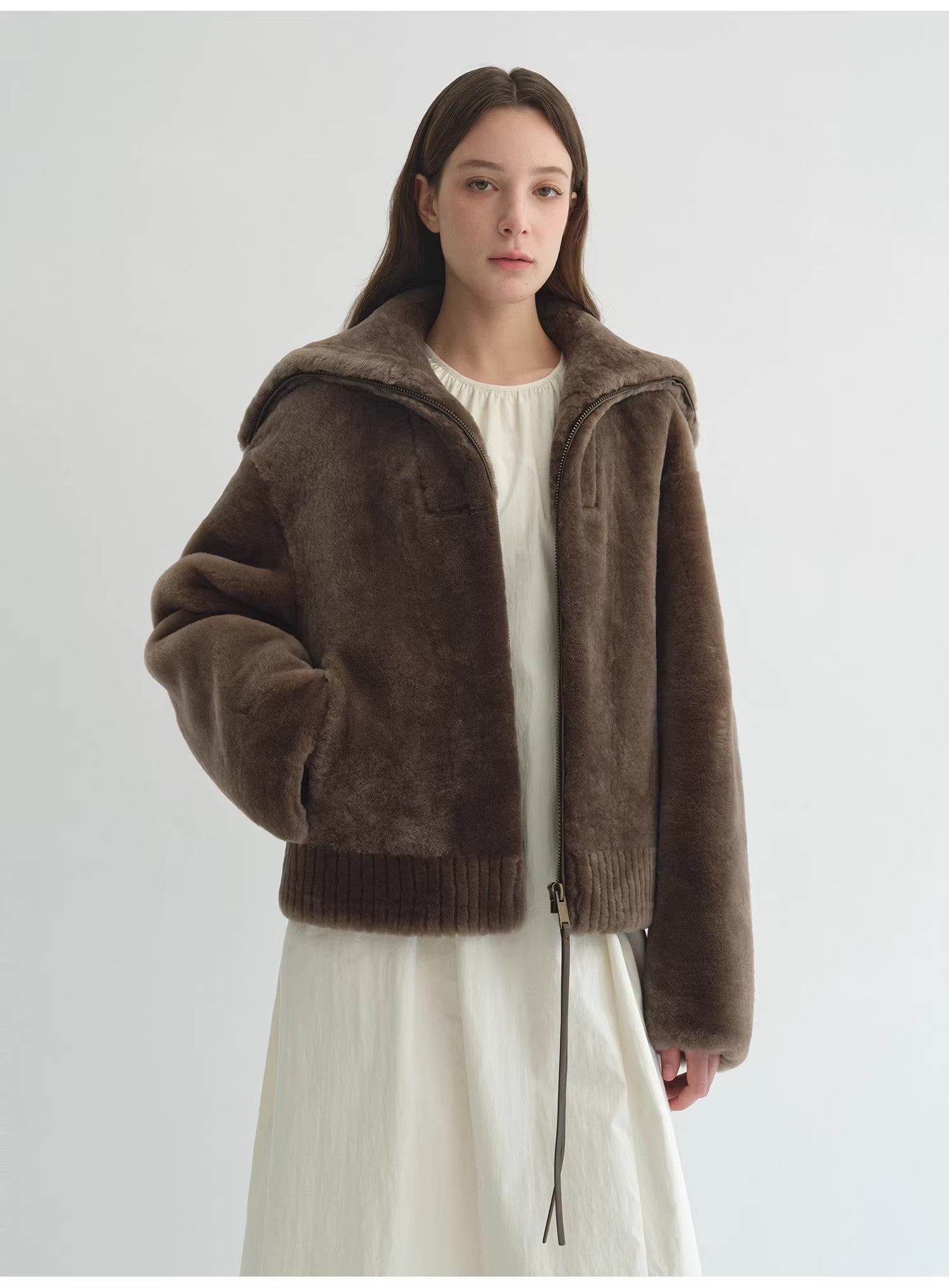 Navy women's shearling leather coat with merino wool blend from Firelady Fur, featuring a short style and cozy collar.