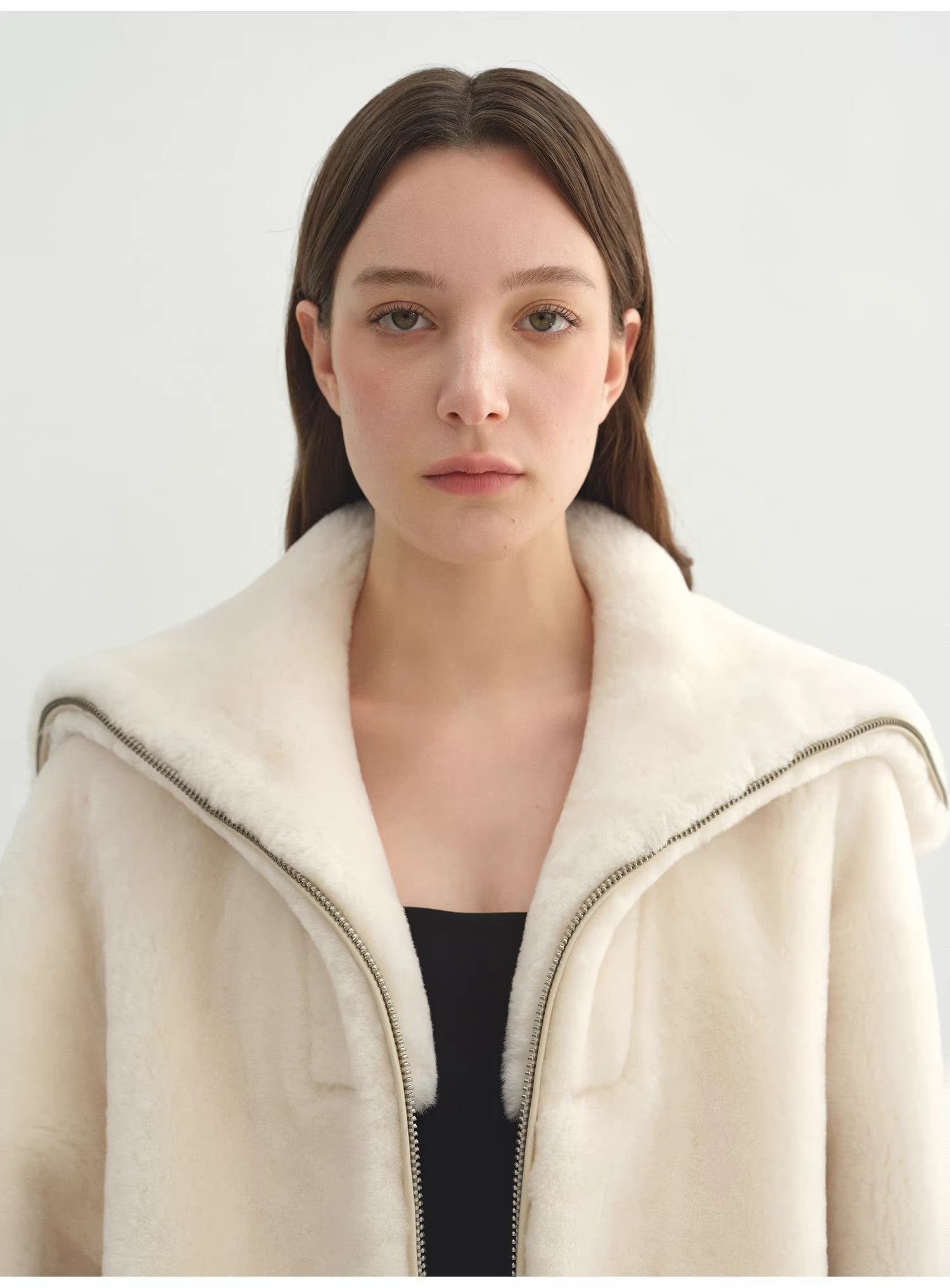 Navy women's shearling leather coat with merino wool blend by Firelady Fur, featuring a short style and cozy shearling collar.
